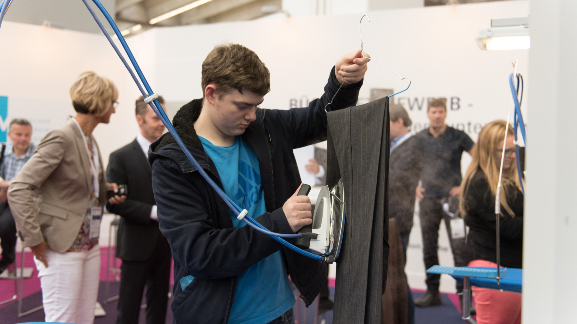 A man irons a pair of trousers