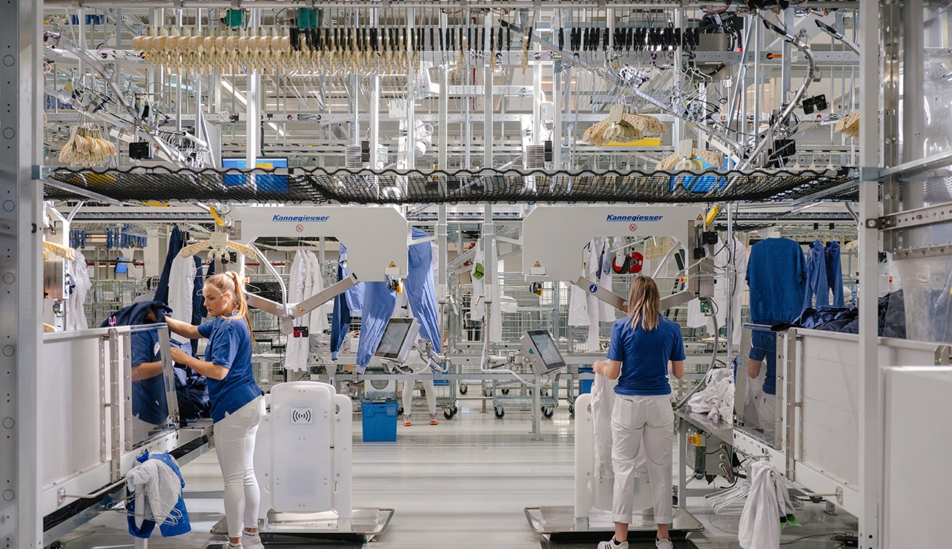 Staff operating an automated laundry sorting system