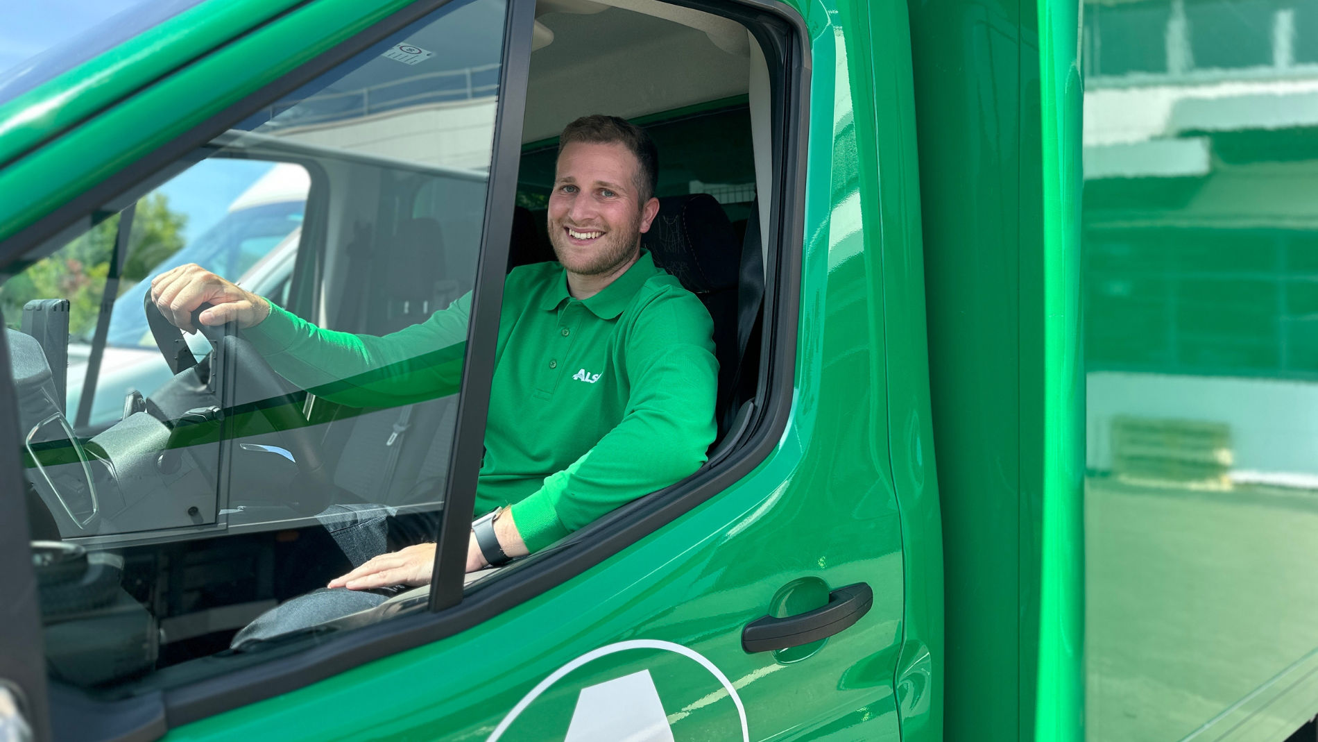 Service driver smiling inside delivery vehicle