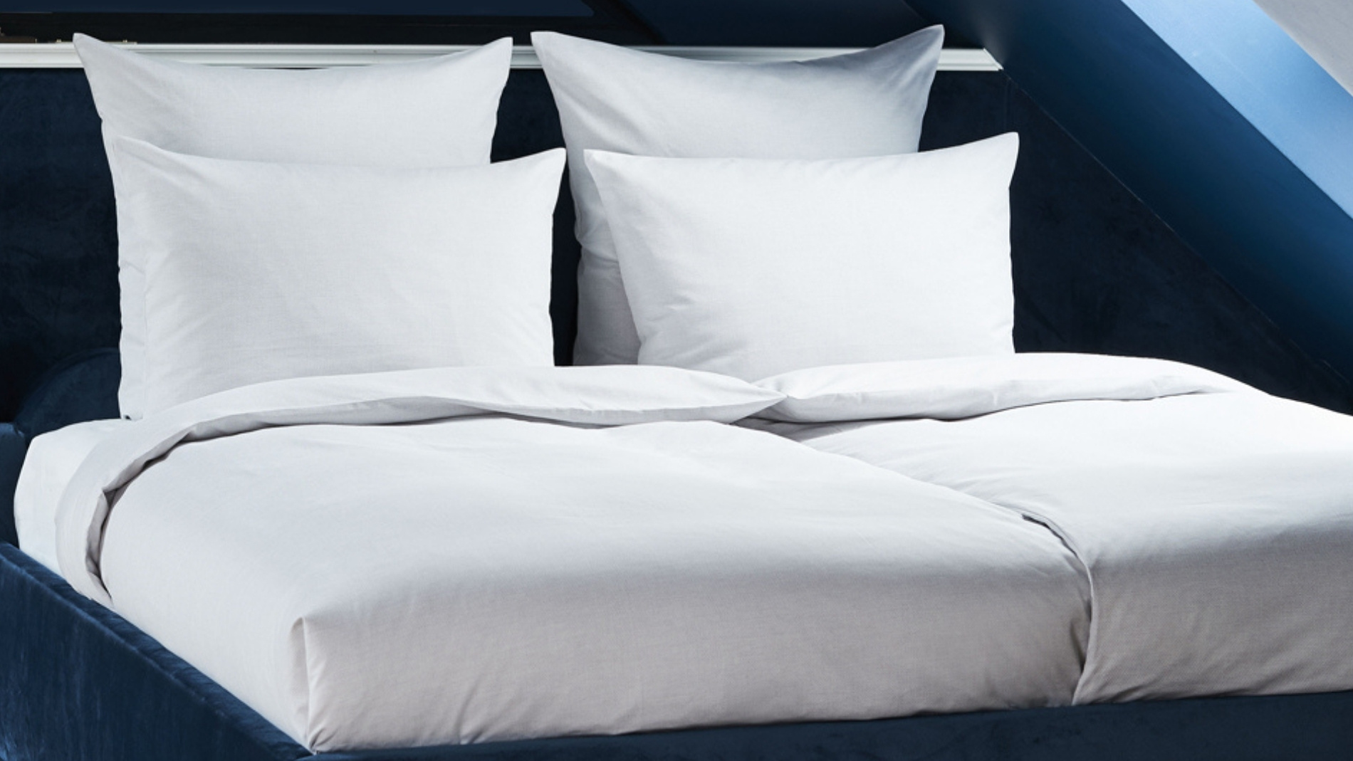 Freshly made hotel bed with white linen